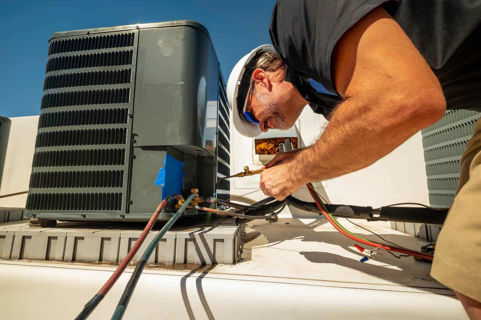 ambient cooling heating service areas parole heating services - Ambient Cooling & Heating A professional HVAC technician taking care of a maintenance job.