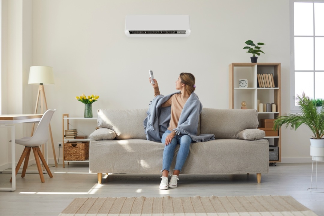 A woman enjoying the cool air from her new mini split system.

